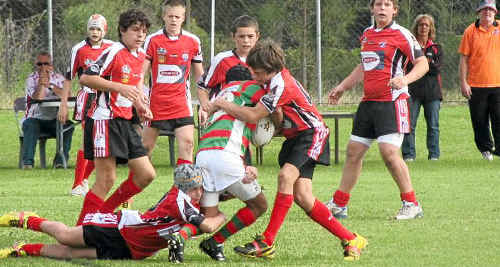 One Group 18 tackler goes low and another high in this classic sandwich tackle in an under-13 game.